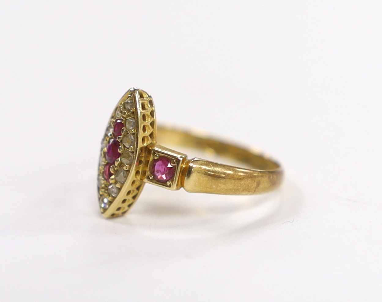 A late Victorian 18ct gold, ruby and diamond cluster set navette shaped ring, size J, gross weight 2.4 grams.
